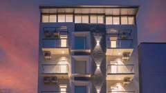 Modern hotel facade illuminated at night with contemporary architecture at Rivido - Manyata.