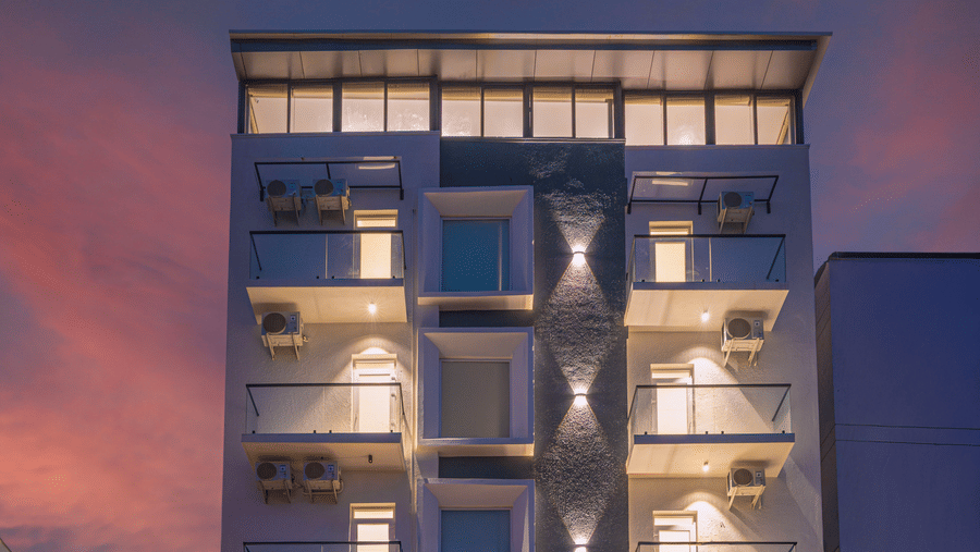 Modern hotel facade illuminated at night with contemporary architecture at Rivido - Manyata.