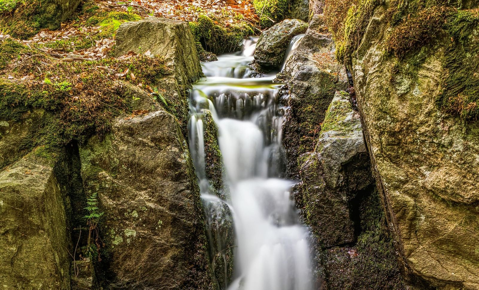An image of water falling on a rock from a waterfall