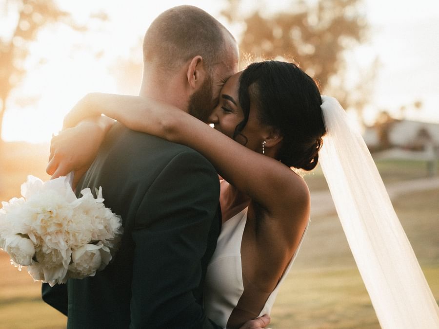 A couple hugging after their wedding