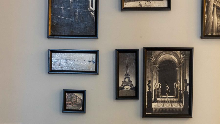 Image of a wall of Coral Premium Room at Coral Reef Hotel and Spa in Port Blair featuring artistic photos mounted on the grey wall