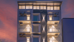 Modern hotel facade illuminated at night with contemporary architecture at Rivido - Manyata.