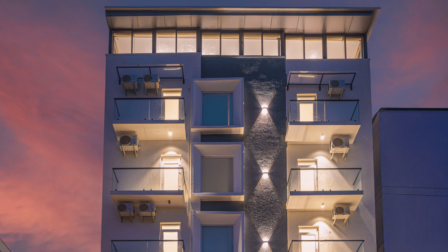 Modern hotel facade illuminated at night with contemporary architecture at Rivido - Manyata.