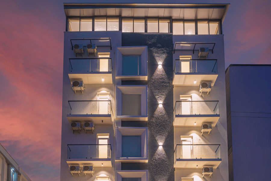 Modern hotel facade illuminated at night with contemporary architecture at Rivido - Manyata.
