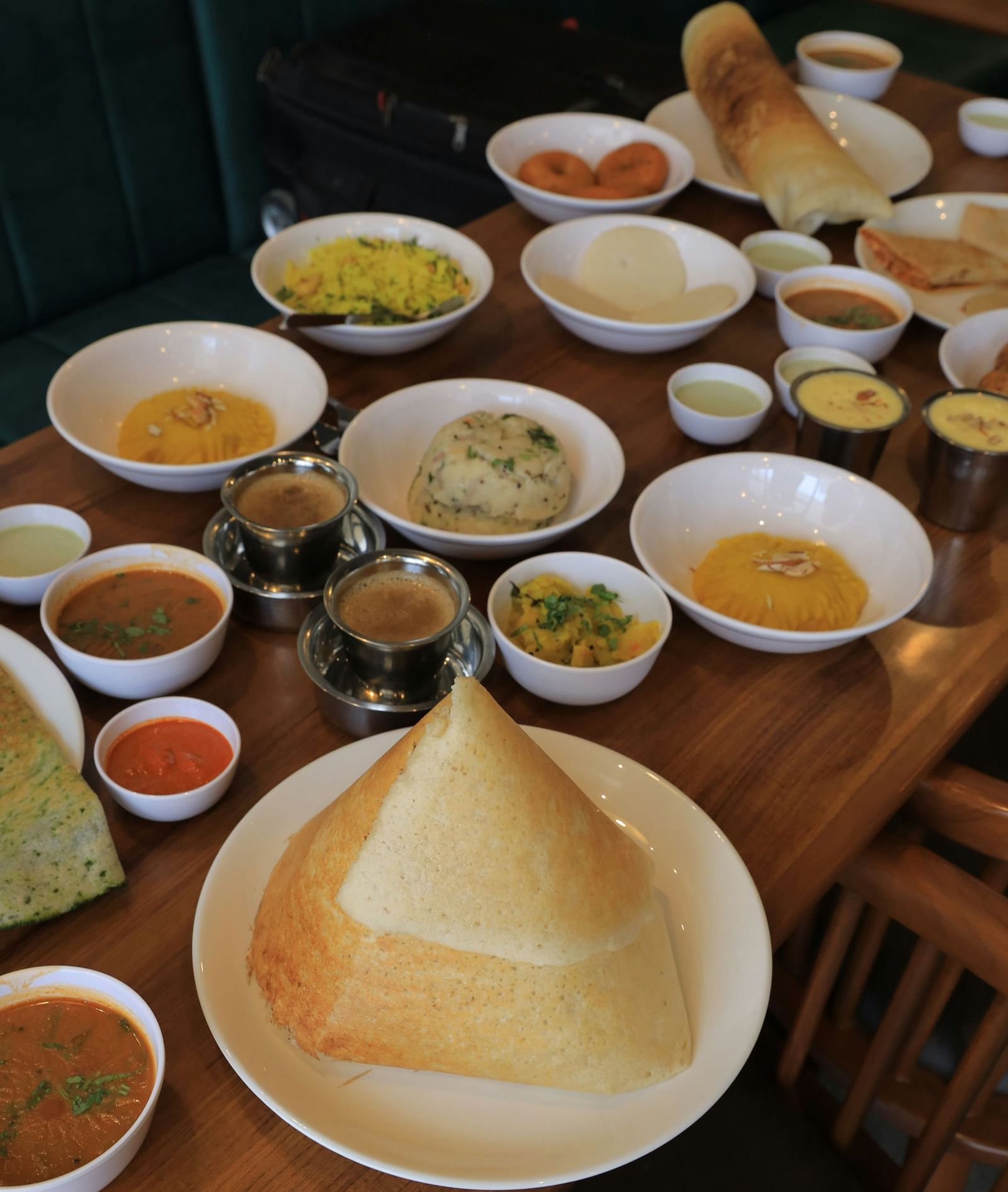 Various South Indian dishes are arranged on the table