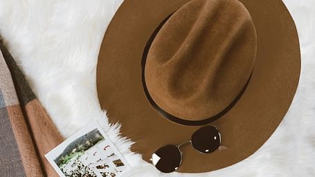  A hat, sunglasses, polaroid images of the trip.  