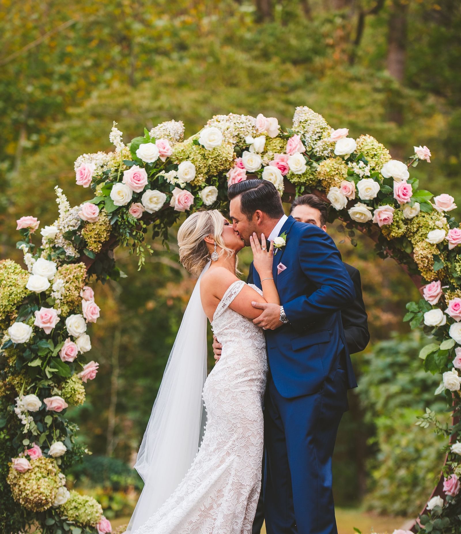 A couple dressed in beautiful wedding attire in a lush green forest - Historic Tapoco Lodge