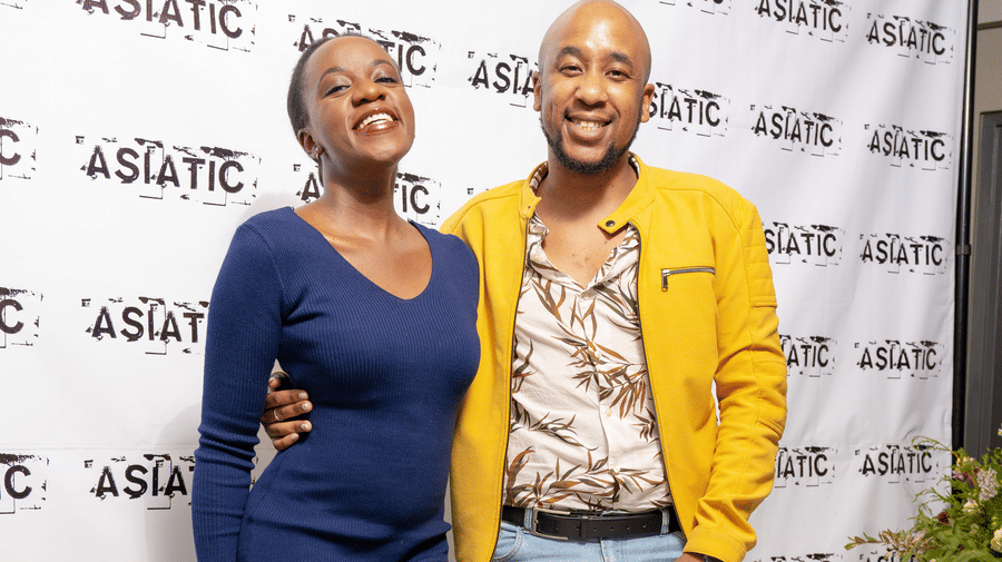 A man and a woman posing for an event at Asiatic Rooftop Bar and Restaurant