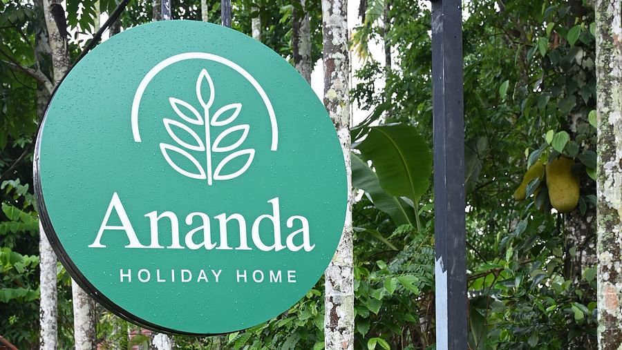A signboard of Ananda Holiday Home, Wayanad