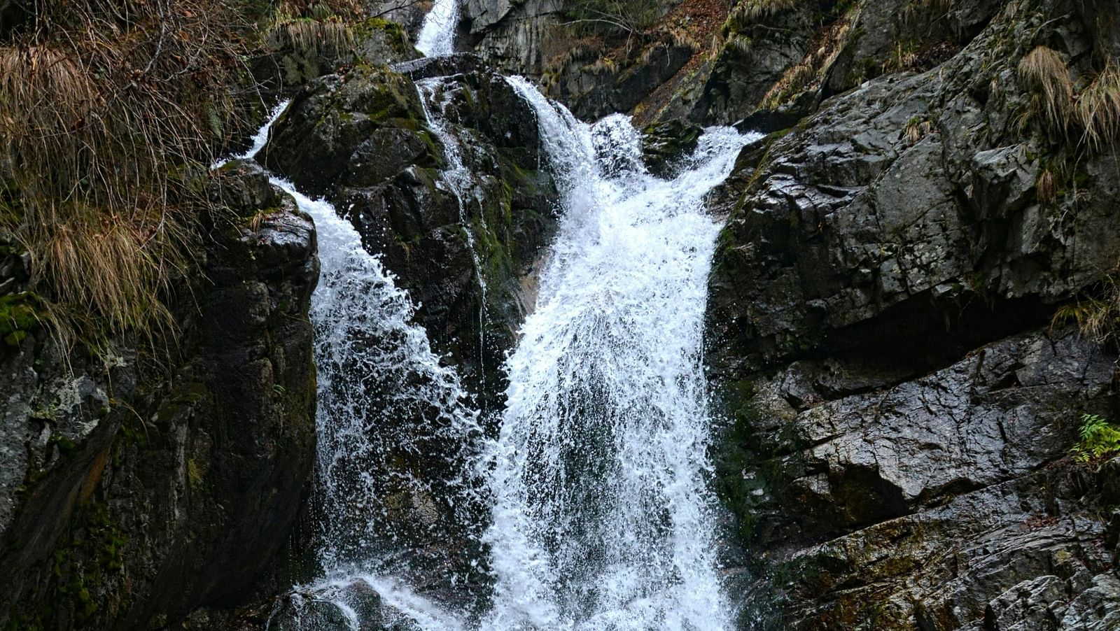 Majestic waterfall cascading through rocky terrain