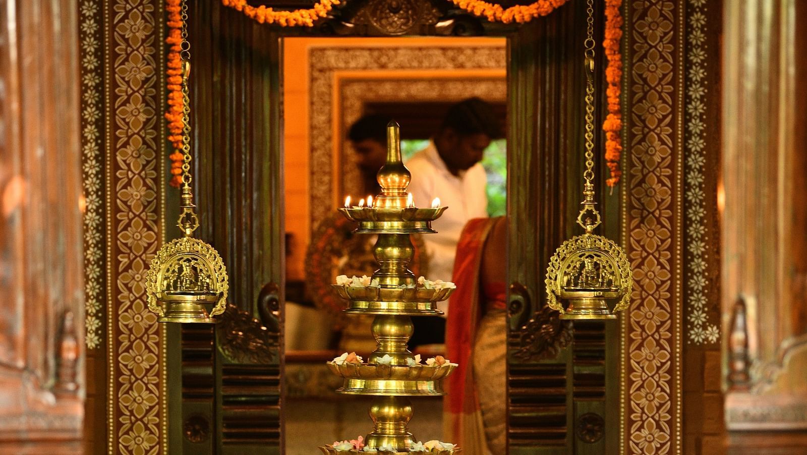image of a branze oil lamp at the enterence of hoysala village resort, hassan