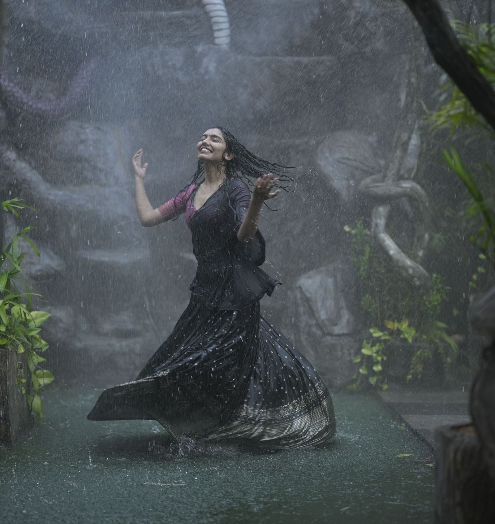 A woman enjoying a Raindance at Parakkat Nature Hotel and Resorts, Munnar