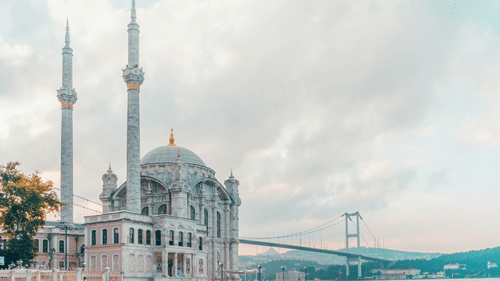 A mosque amidst waters and clear clouds