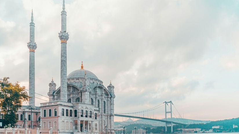 A mosque amidst waters and clear clouds