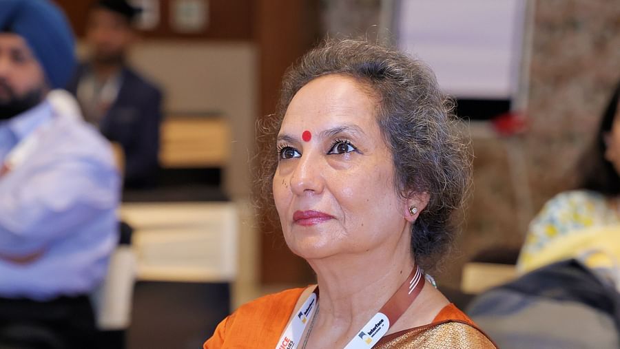 Woman in traditional attire seated at an event - Karma Lakelands.