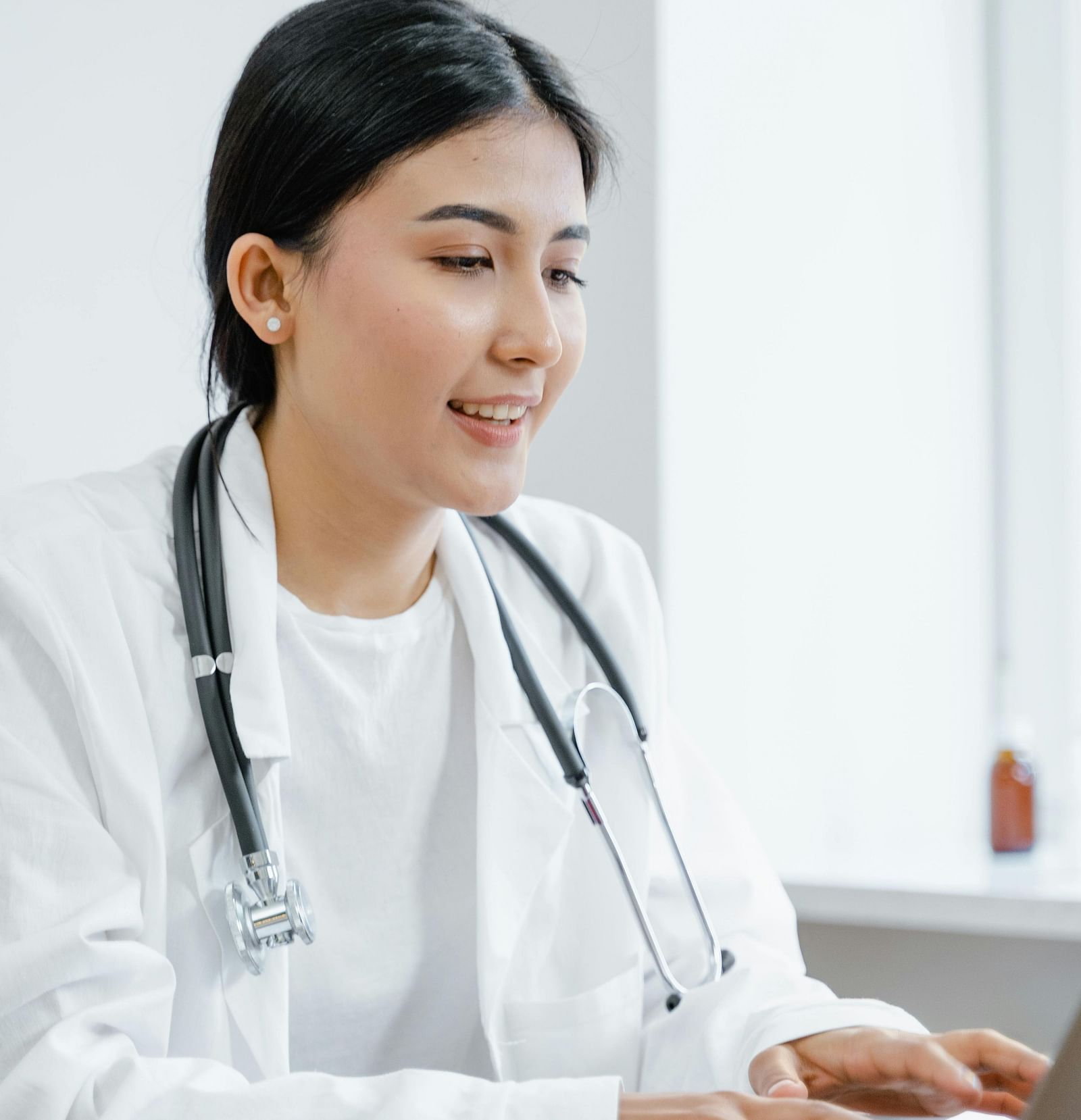 an image of a doctor working on her laptop