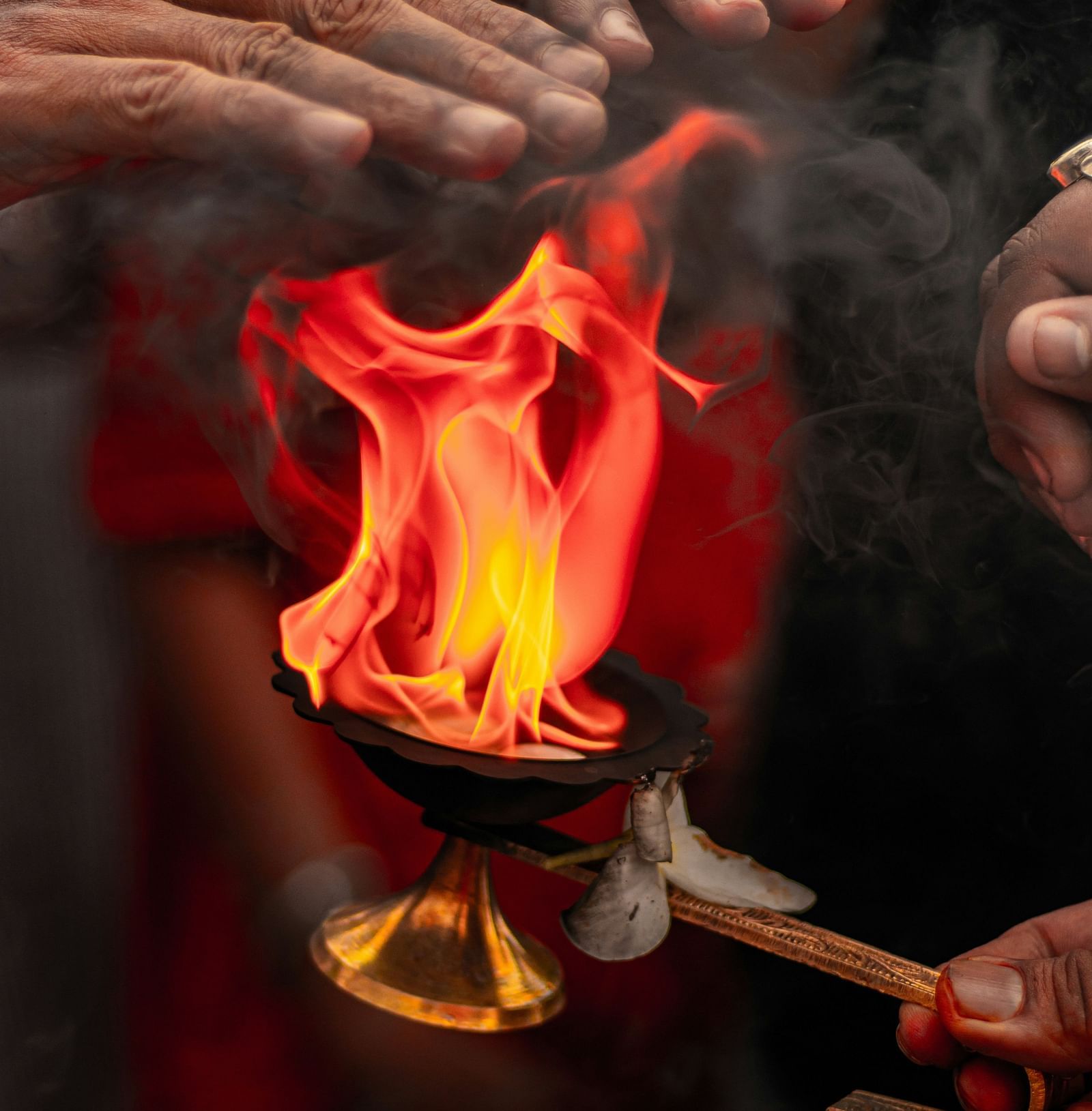 A person receiving a blessing from an aarati