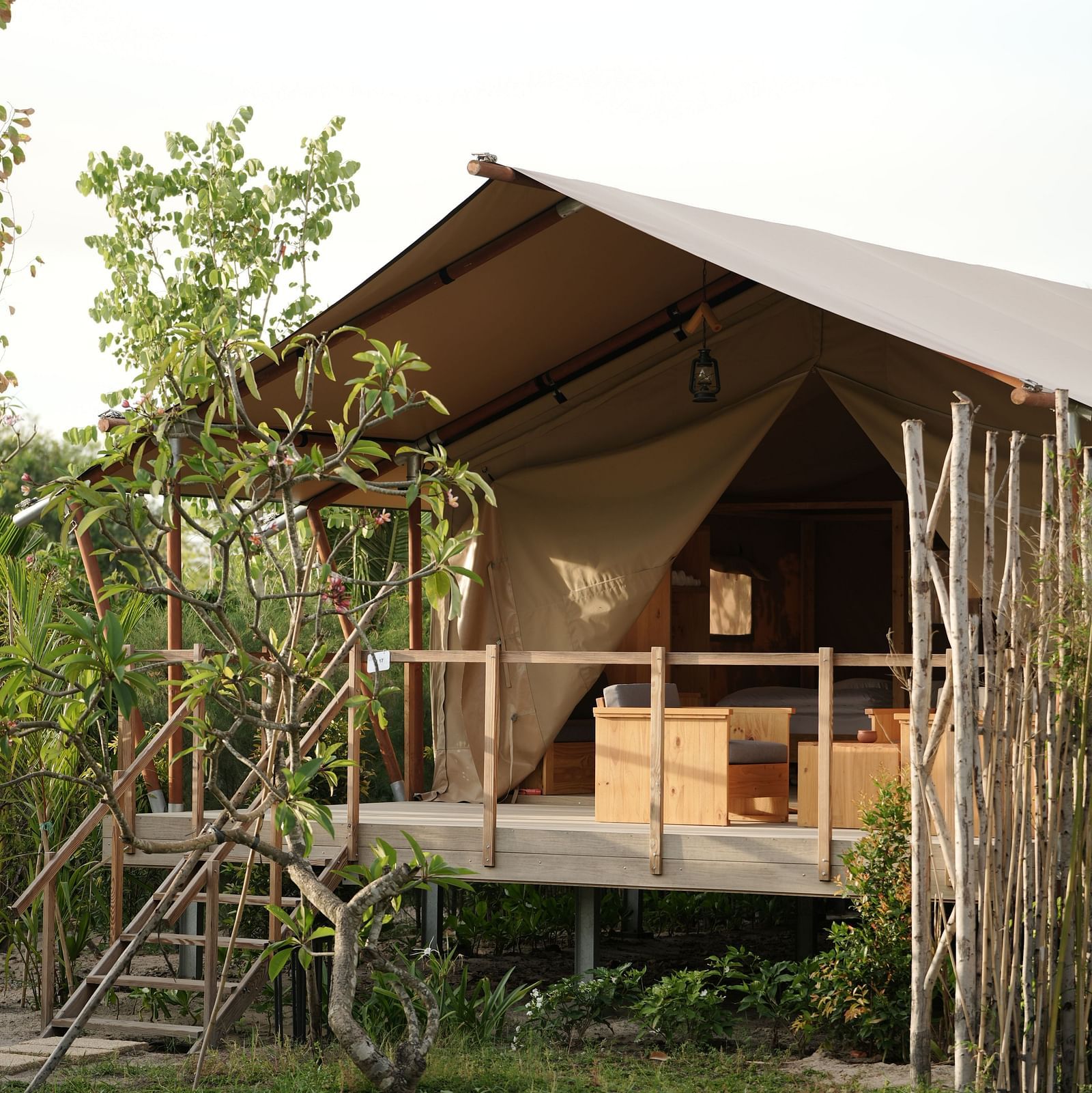 A scenic view of the Mindful Tent at WoCAL Retreat Ke Ga surrounded by lush green landscaping and open space.