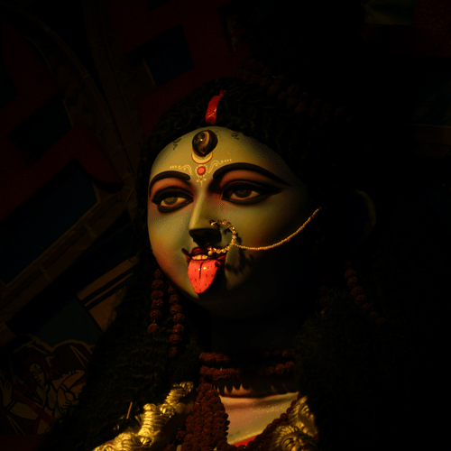 a picture of Goddess Kali with a black background - polo floatel kolkata