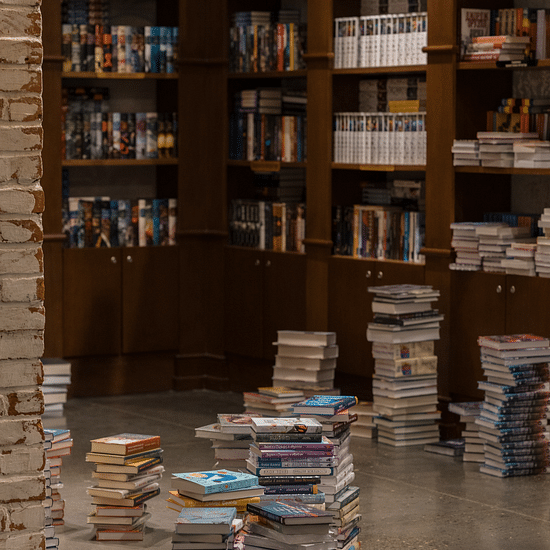 Image of lots of books inside and outside the bookshelf