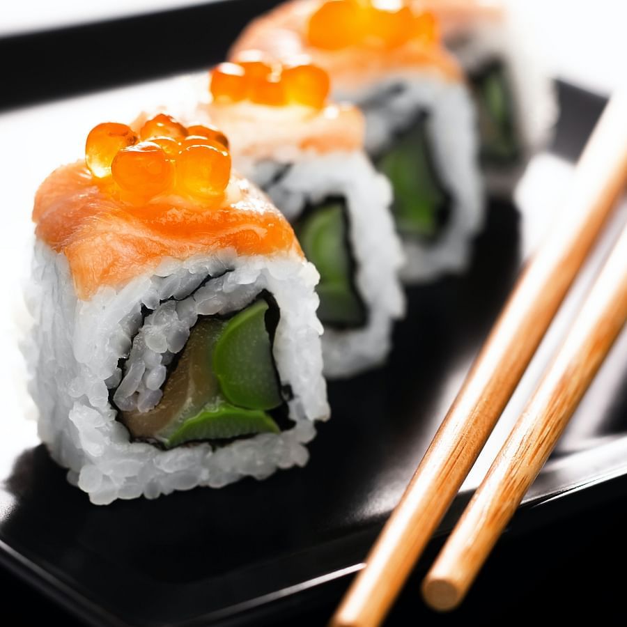 sushi on a plate with chopsticks
