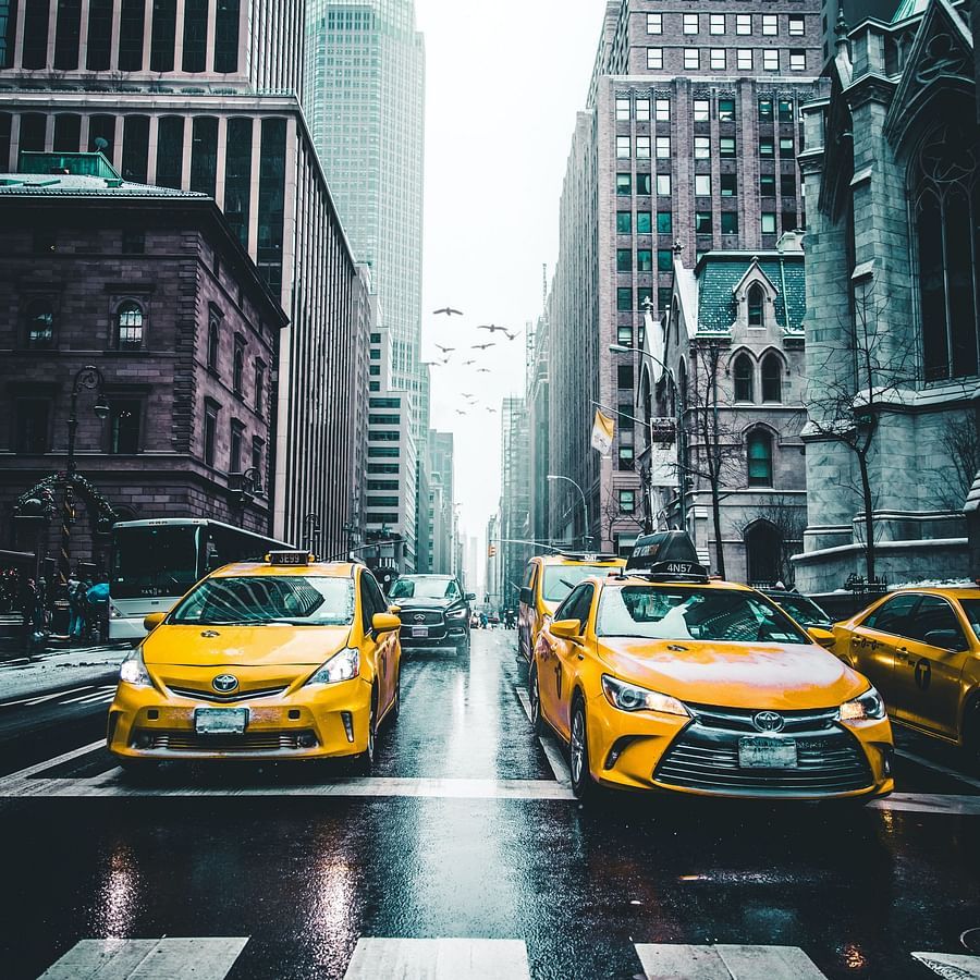 A long shot of taxis moving around on the road