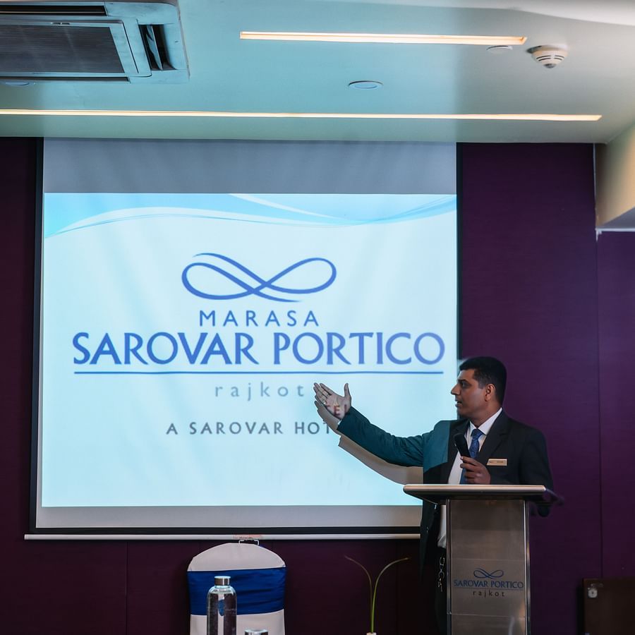  A man presenting the at banquet hall in Marasa Sarovar Portico, Rajkot
