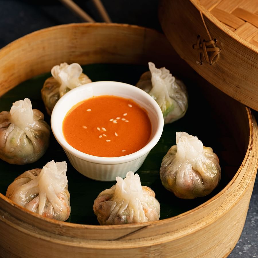Momos with a dip served in a container