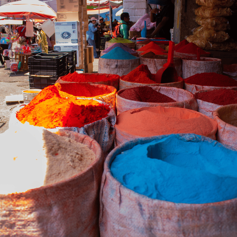 A close up of inside a street vendor's shop in Mercano Market, the largest open-air market in Africa, with different types of powders being sold.