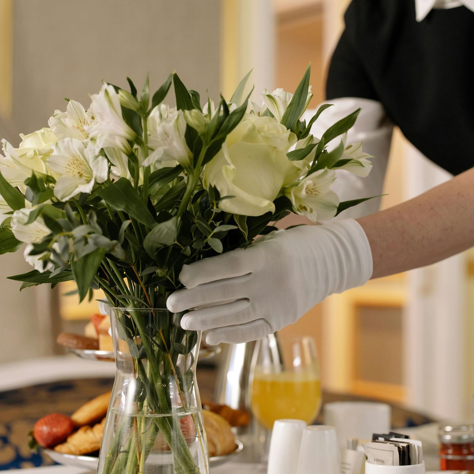 A woman arranging flowers in a vase