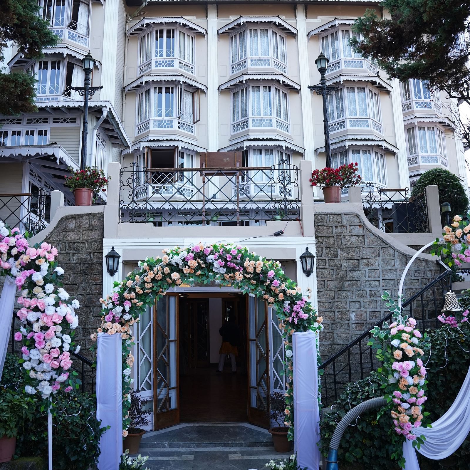Portrait view of the decorated facade of the multi-storey Cedar Inn with colonial architecture in Darjeeling.