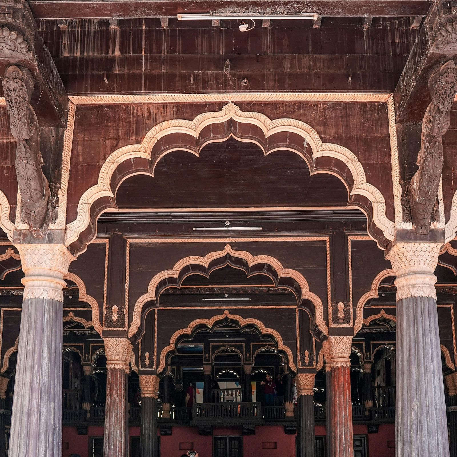 an image of the entrance of tipu sultan summer palace with pillars 