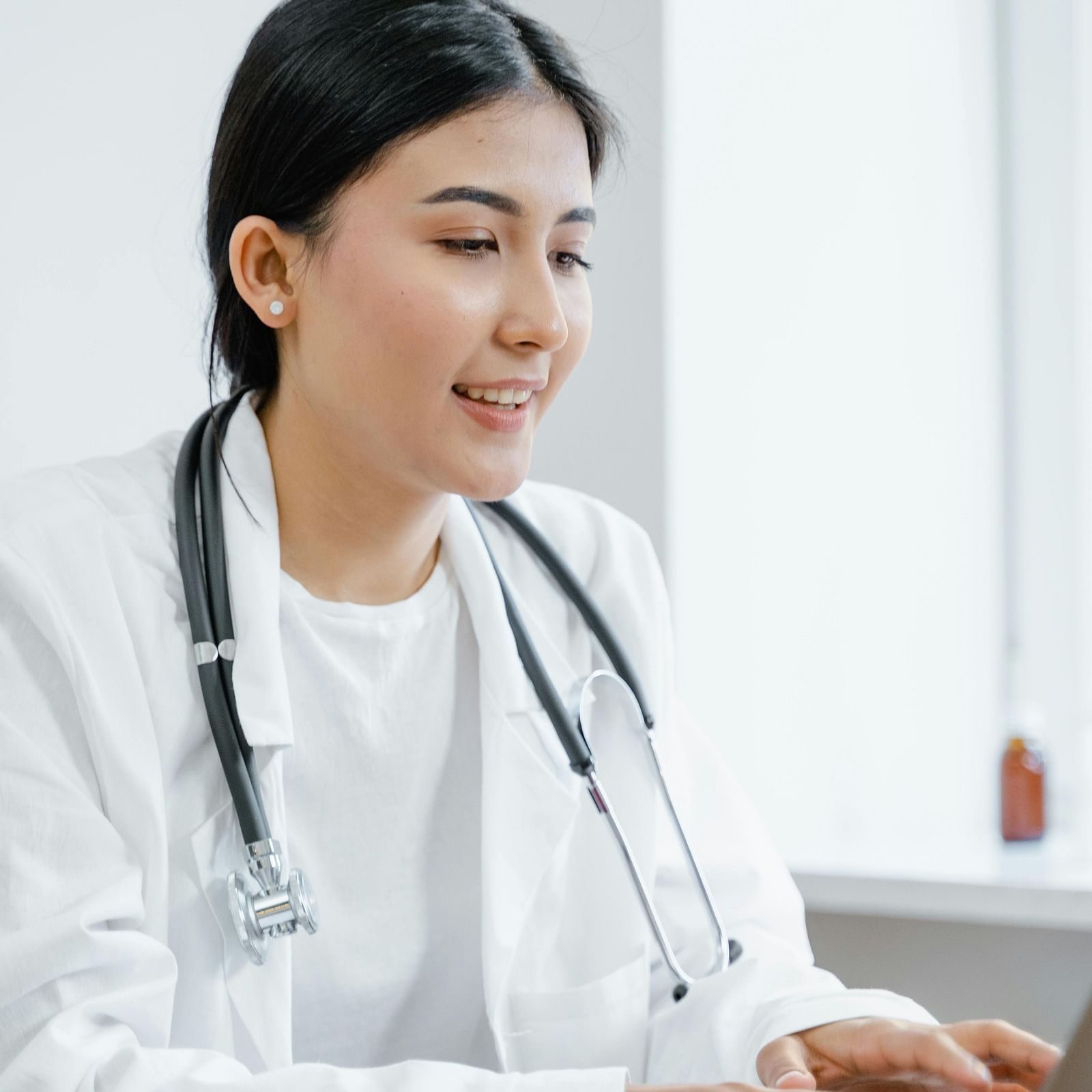 an image of a doctor looking into her laptop