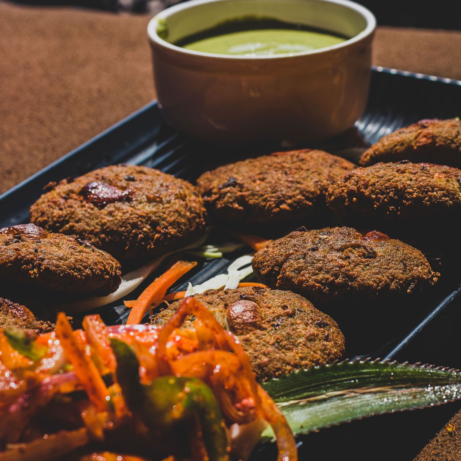 A platter of Indian appetizers served along with chutney.