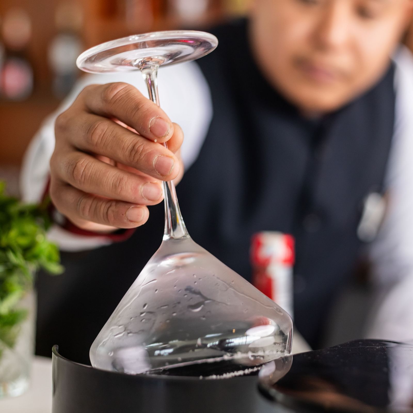 A bartender rimming a martini glass at Mandala Norling Lords Prime in Kathmandu.