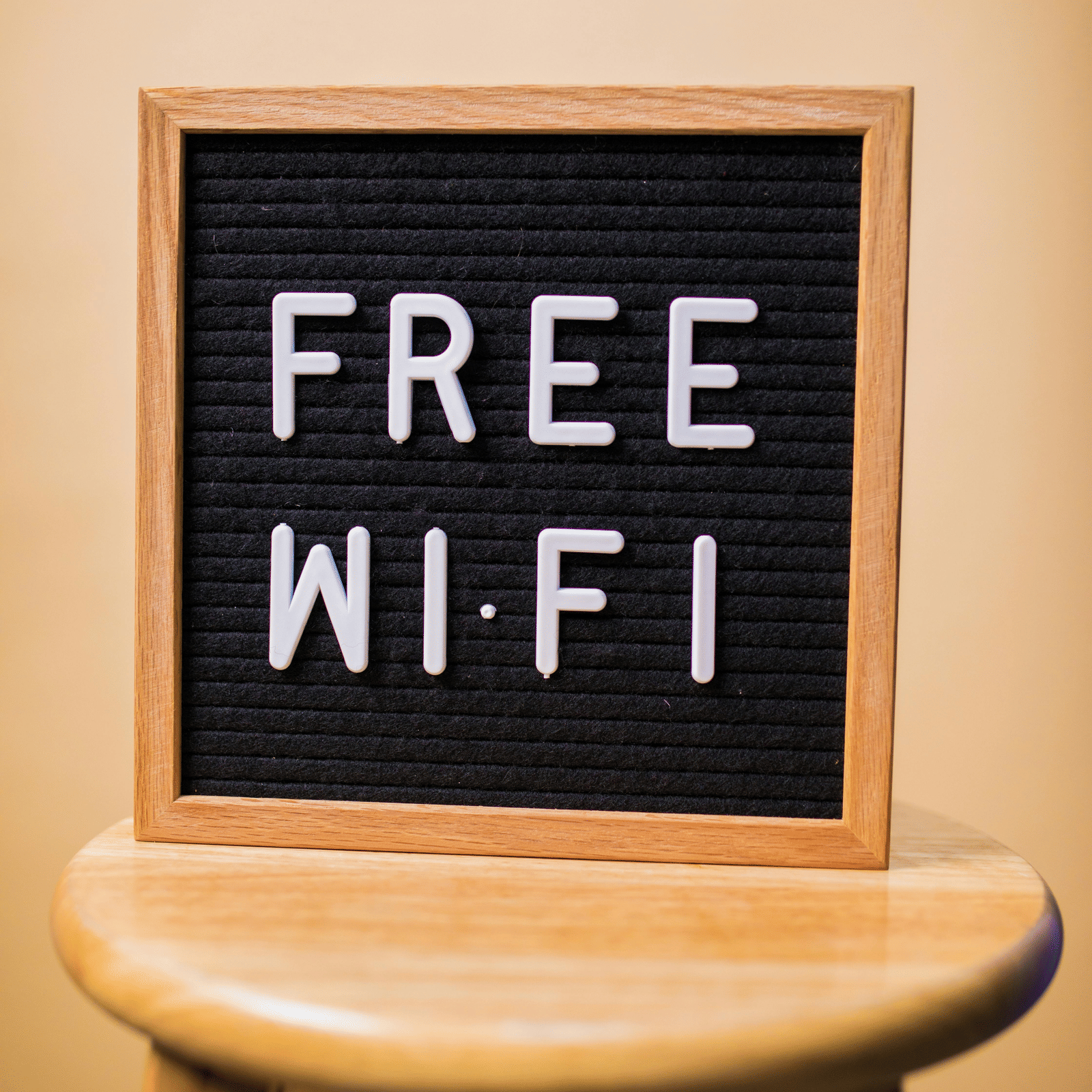 'Free Wi-Fi' written on a board that's placed on a stool.