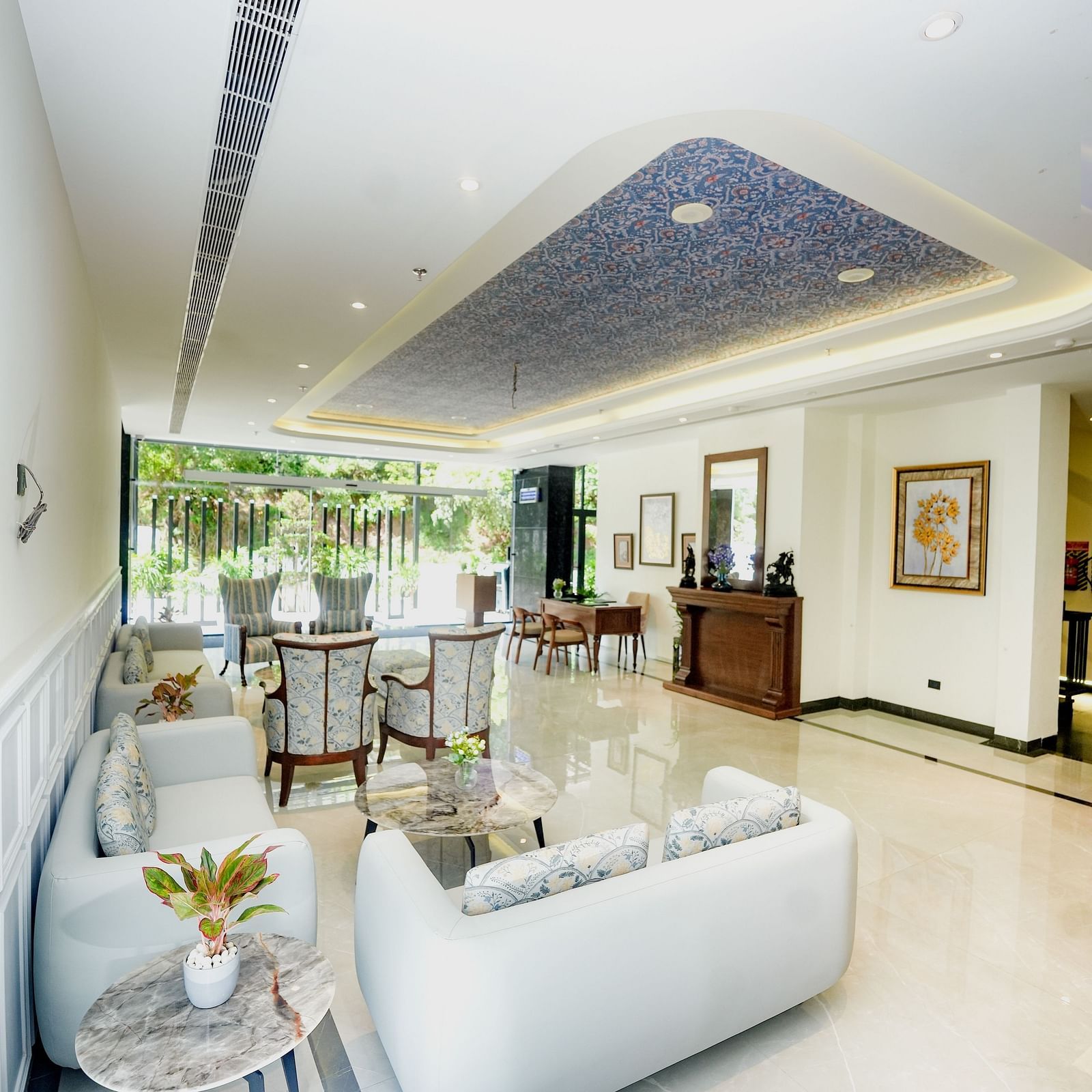 An image of a lobby area featuring a sofa, upholstered chairs, teapots, and a reception desk - NAMAMI BY ZENQ BANKHANDI