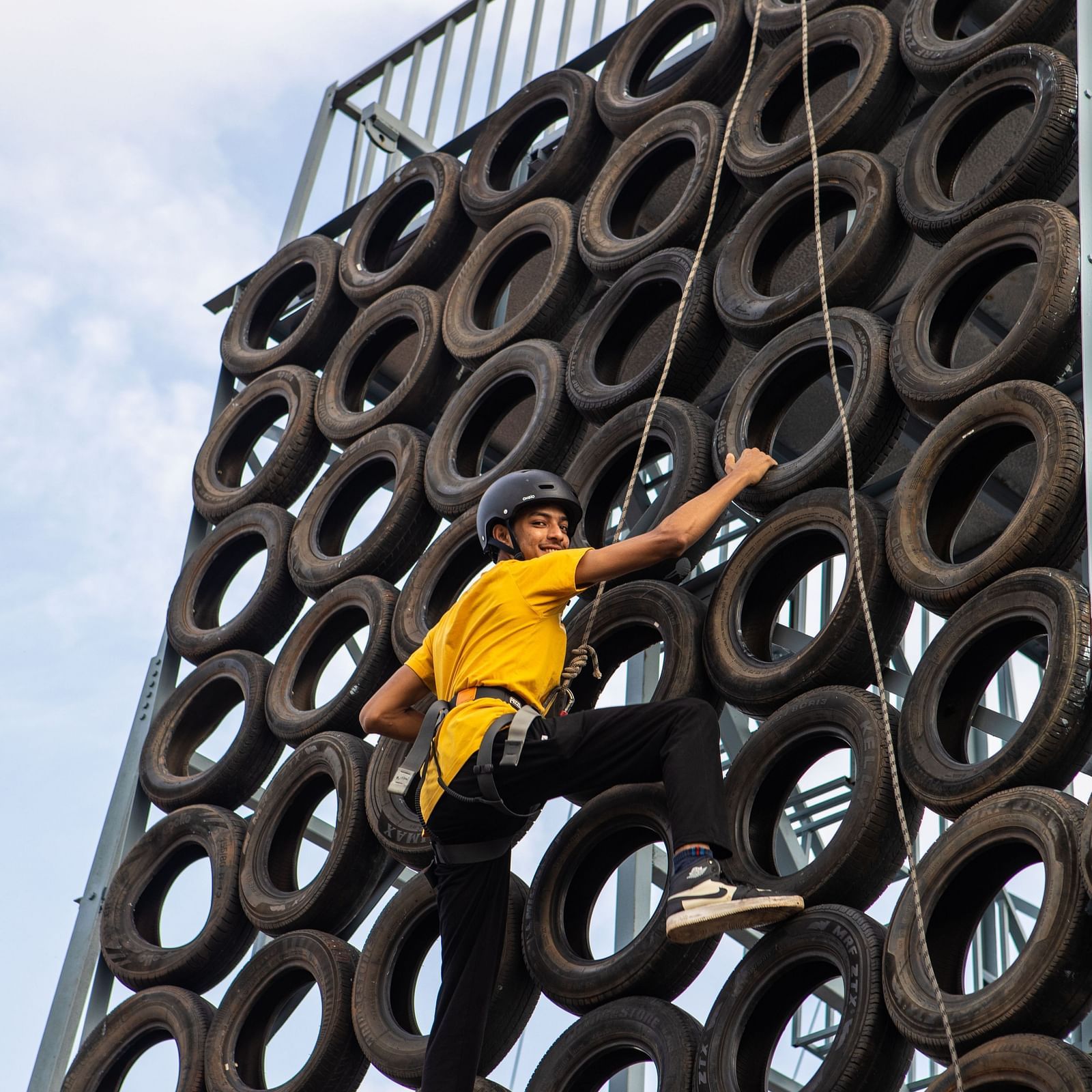 An image of a person doing the activity of tyre climbing - Trance Veechika Resort, Vikarabad