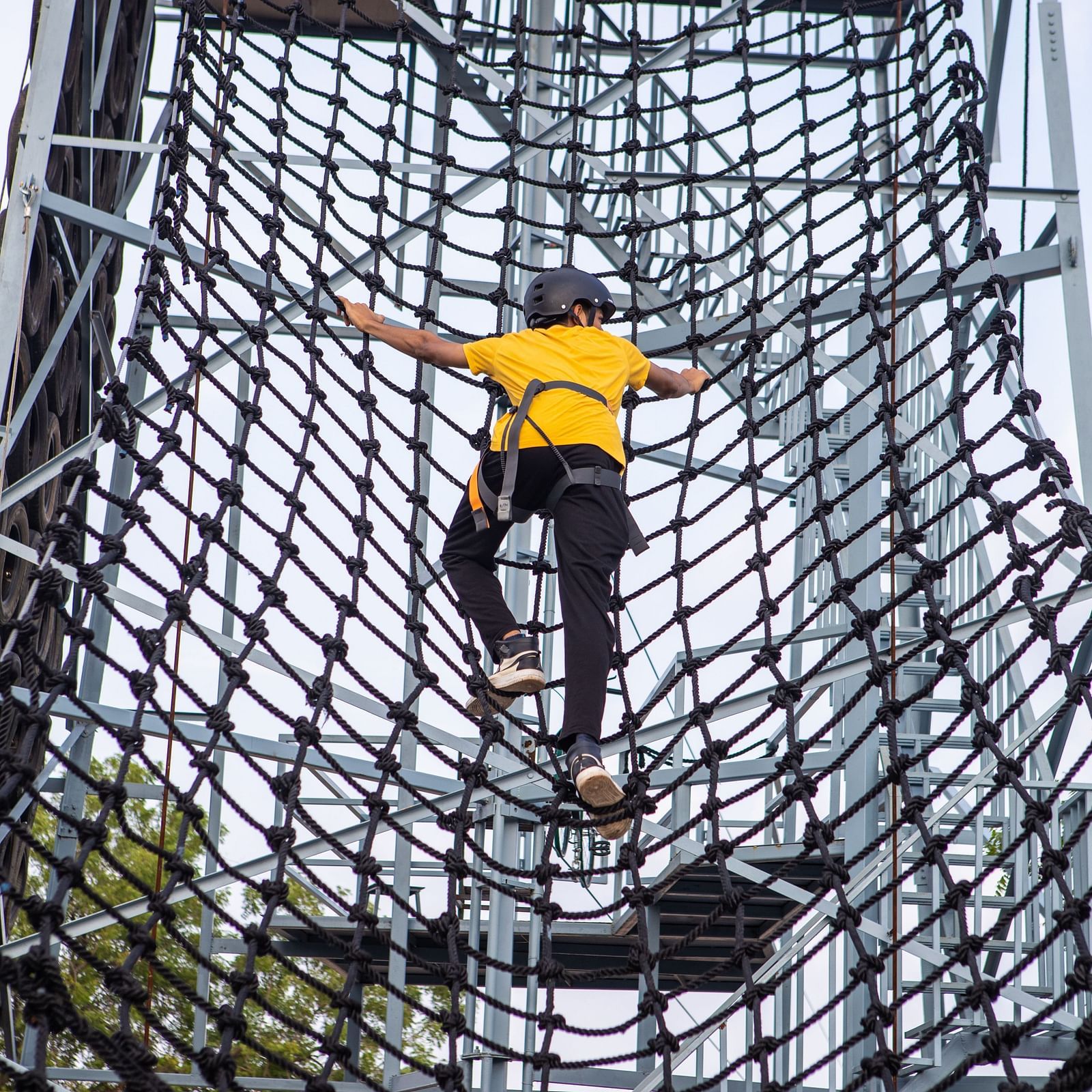 An image of a person doing the activity of net climbing - Trance Veechika Resort, Vikarabad