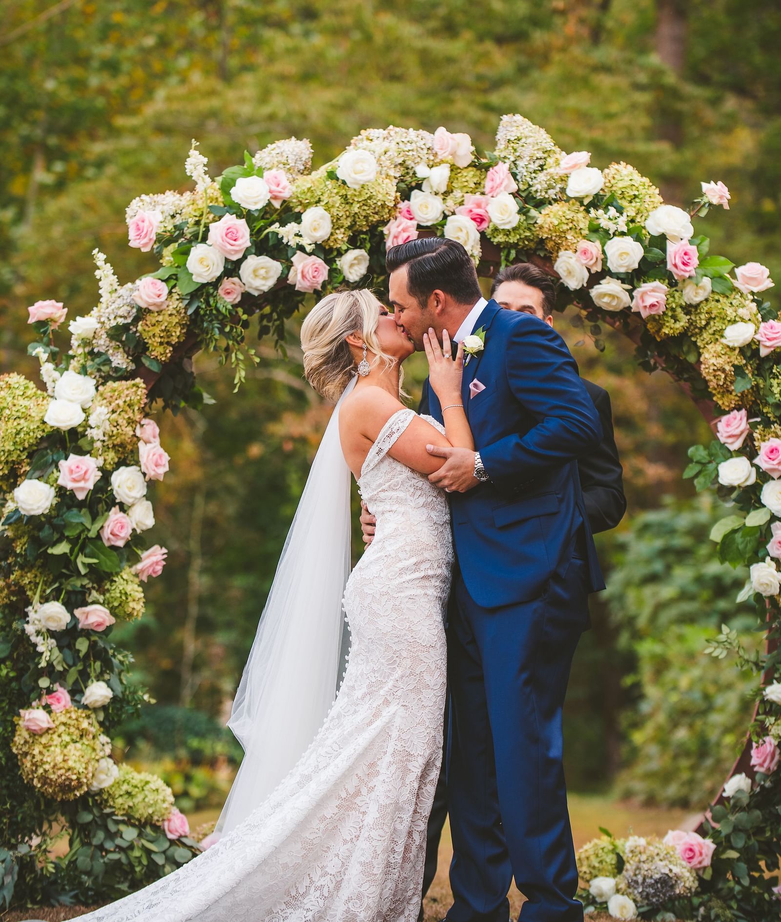 A couple dressed in beautiful wedding attire in a lush green forest - Historic Tapoco Lodge