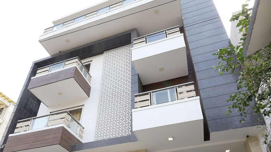 A contemporary building with a unique stacked design and balconies is viewed from a low angle - Asian Suites Cyber Park, Gurgaon