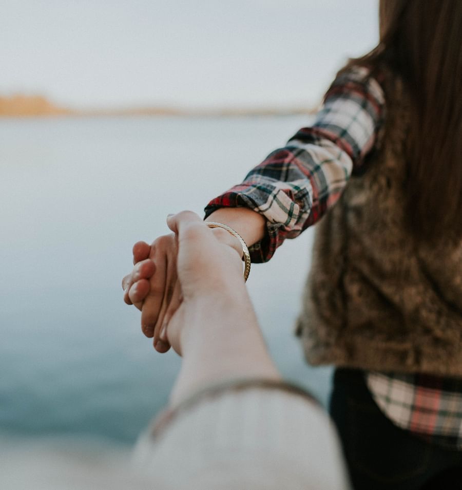 a man holding the hand of his partner 
