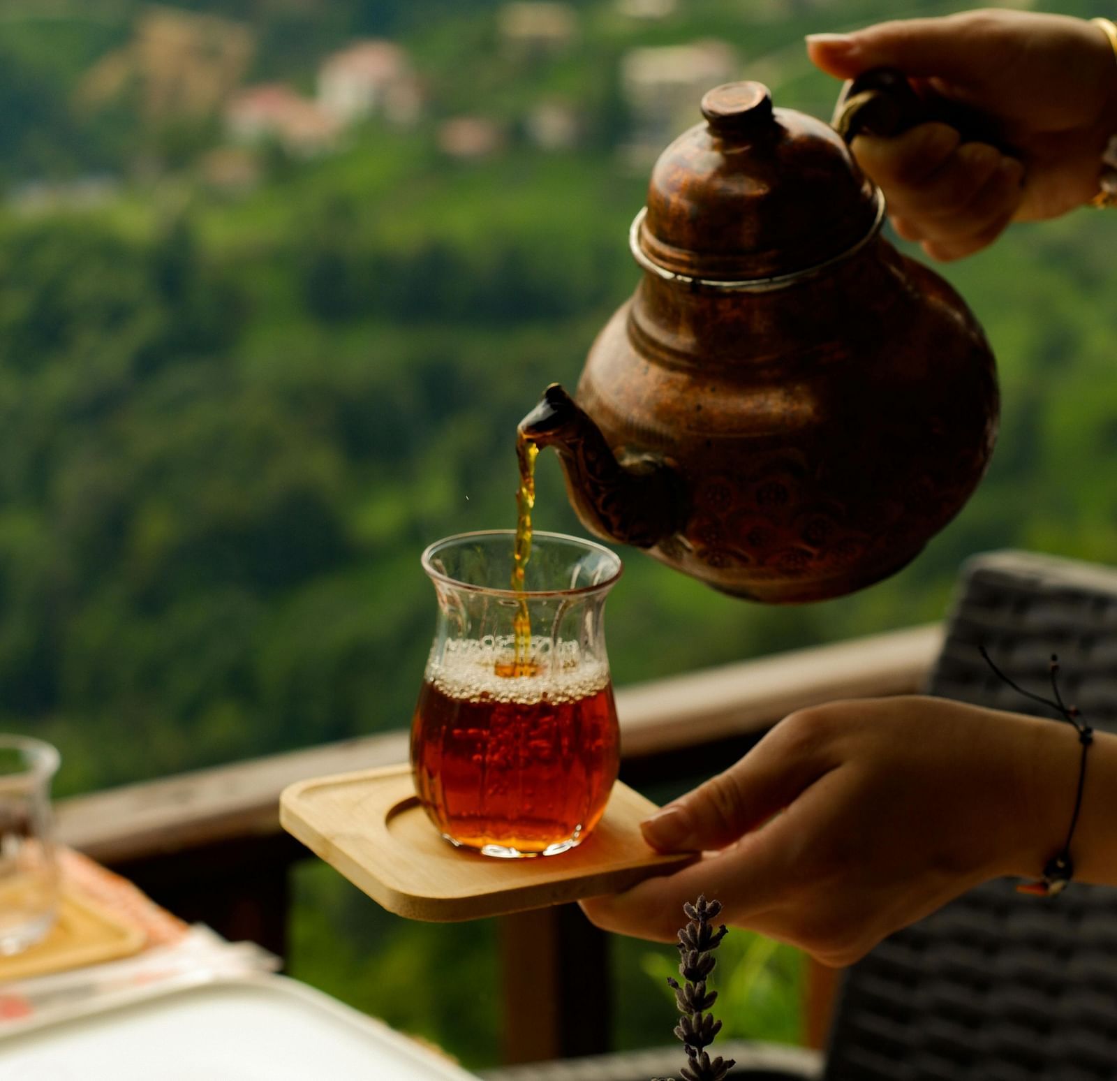 A cup of tea is served with a beautiful backdrop of mountain.