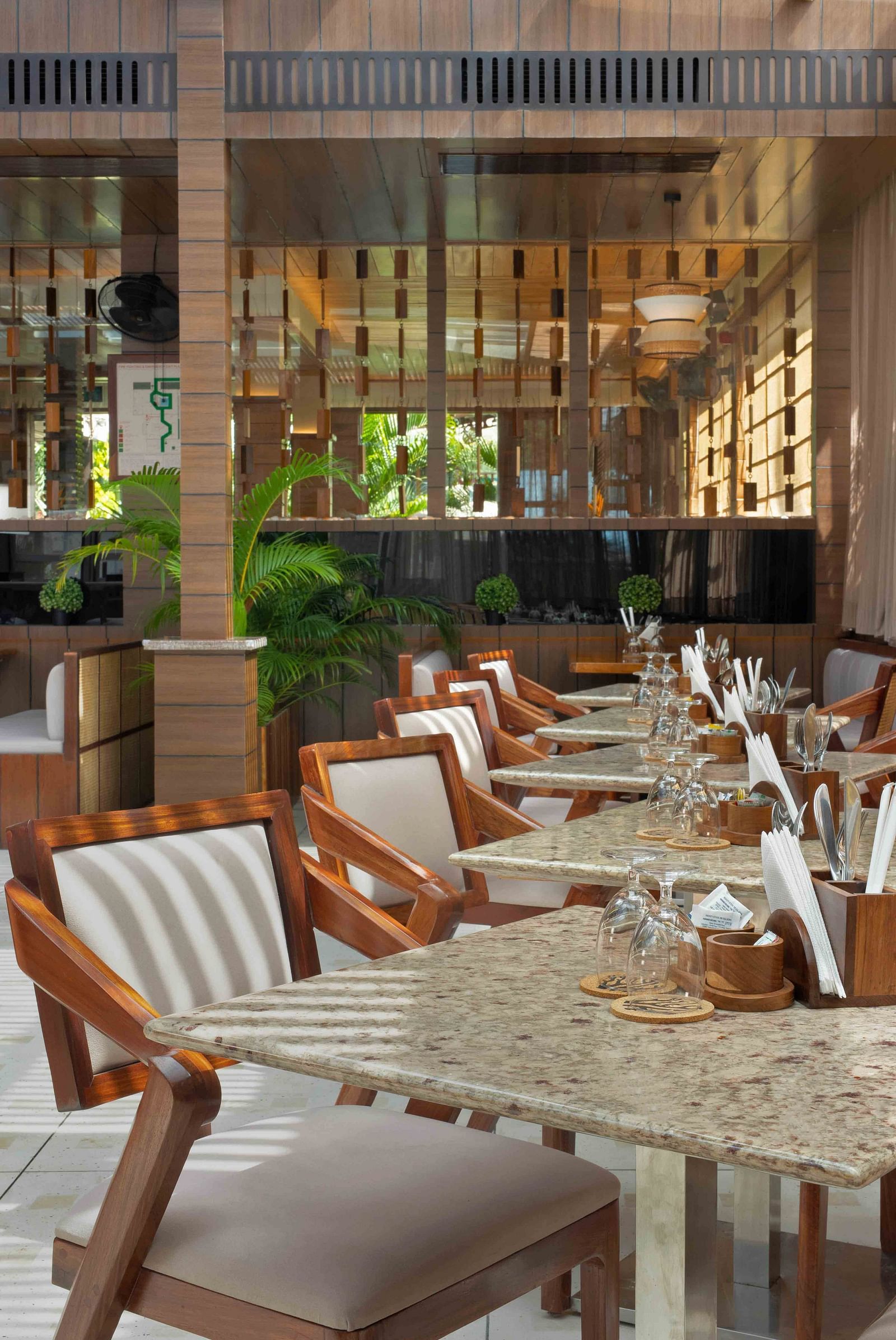 A bunch of chairs and tables neatly arranged inside a cafe