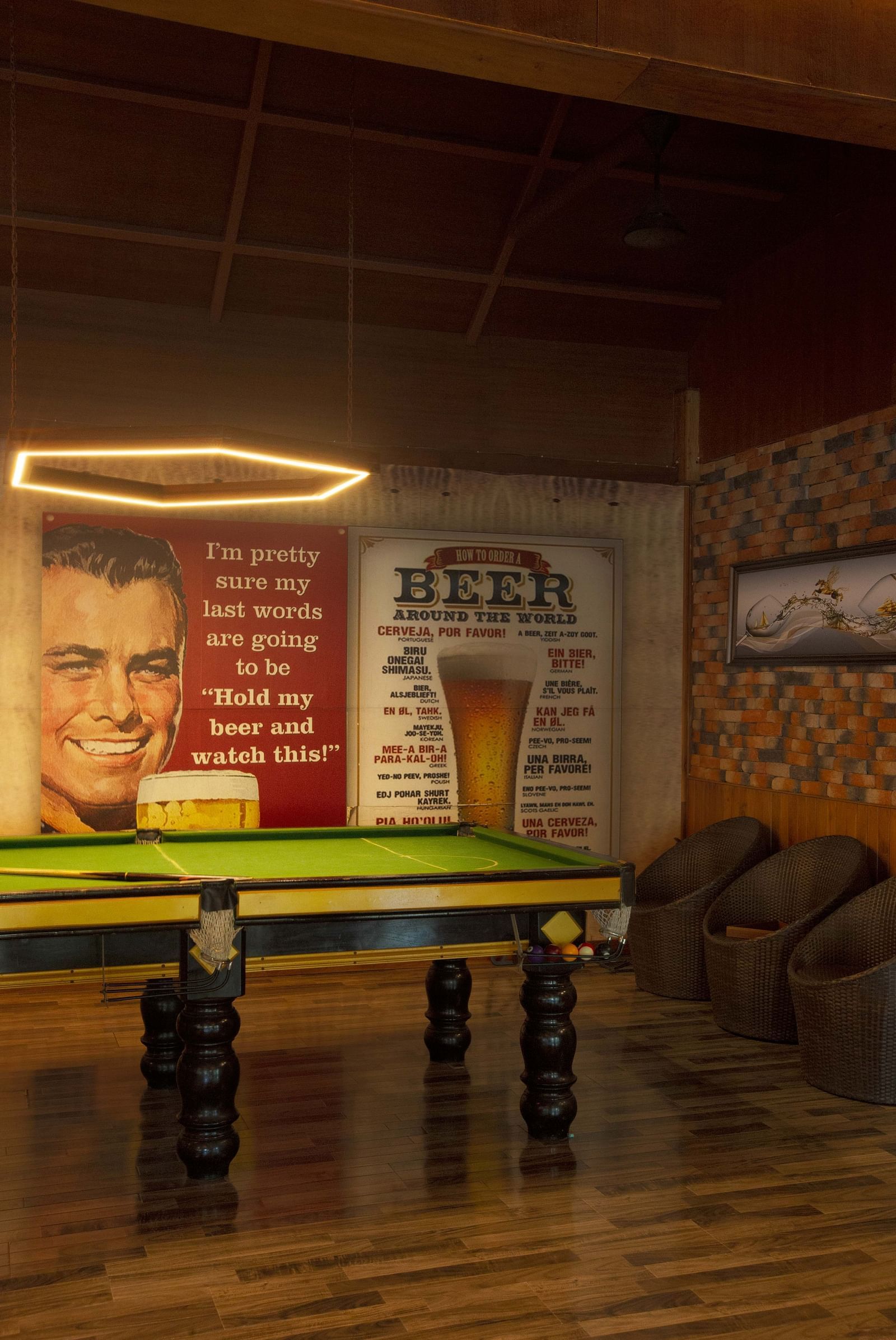An indoor pool next to a large portrait of a smiling man.