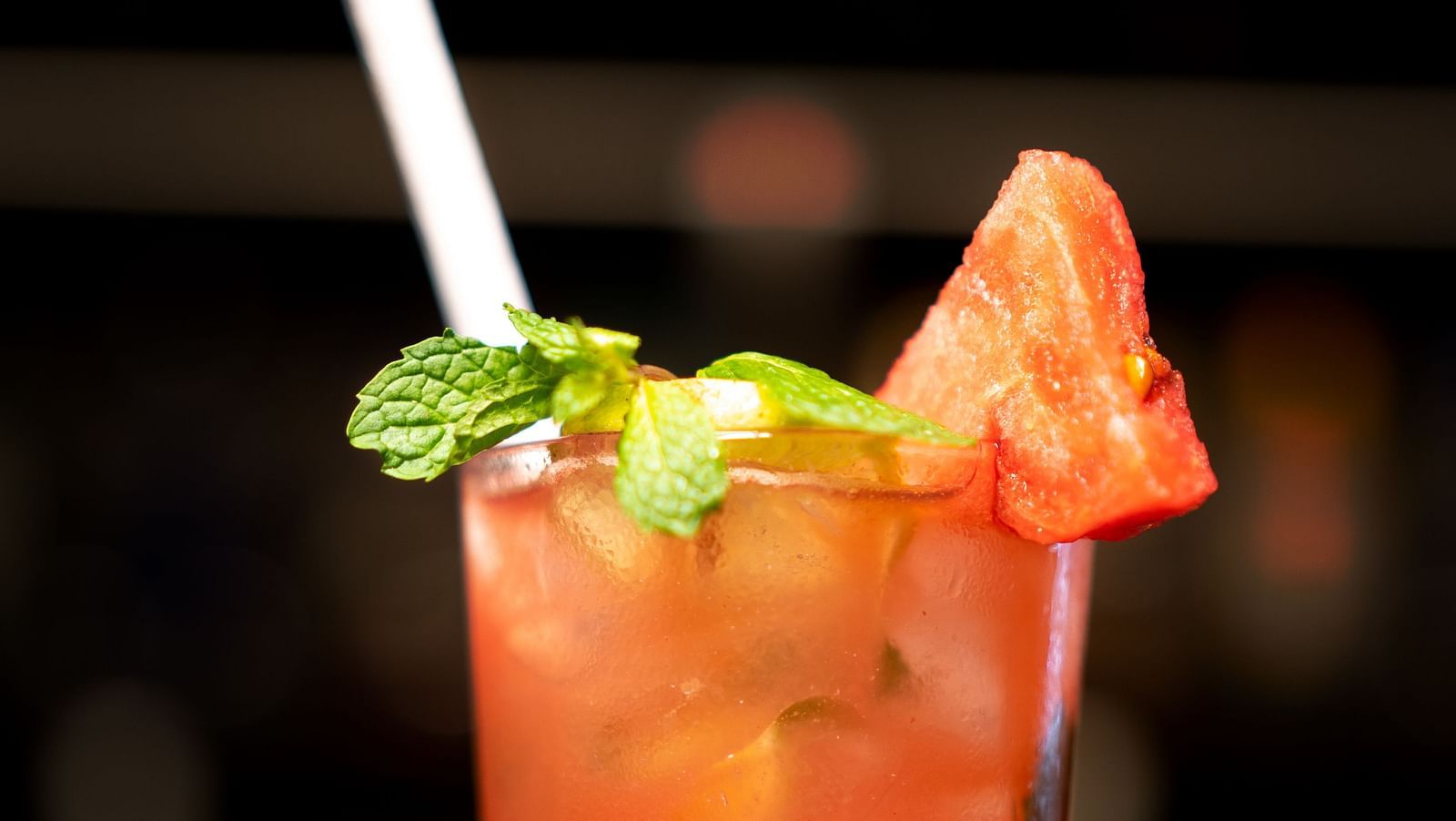 A close-up of a strawberry cocktail garnished with mint on a bed of crushed ice - TGI Ameya Grand, Goa