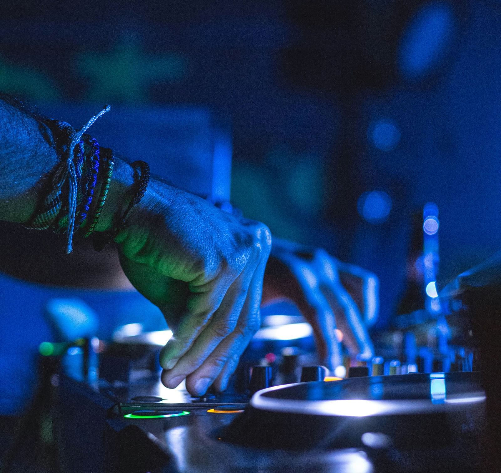  Under the disco lights, the DJ expertly manipulates the beats on his device, creating a pulsating rhythm that energises the dance floor.
