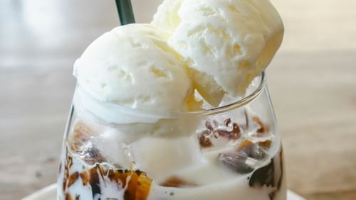 Ice cream on a glass placed on a plate with a spoon