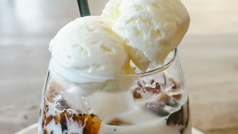 Ice cream on a glass placed on a plate with a spoon