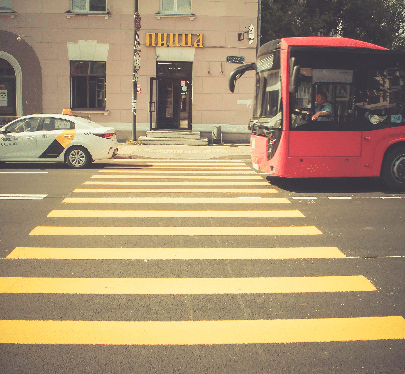 A yellow coloured pedestrian footpath leading towards the building.